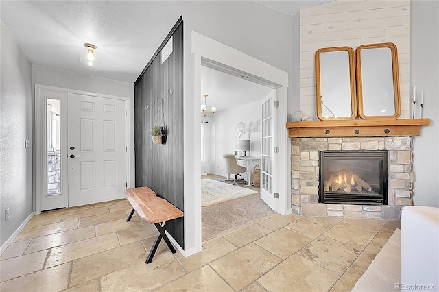 3838 Brush Rd, Castle Rock, CO 80108 - foyer entrance with stone tile flooring, baseboards, and a fireplace