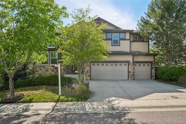 13075 Tamarac St, Thornton, CO 80602 - view of front of house featuring a garage, stone siding, and driveway