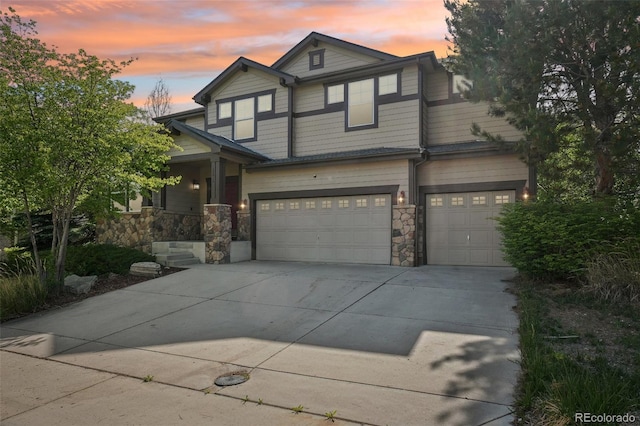 13075 Tamarac St, Thornton, CO 80602 - view of front of house featuring stone siding, concrete driveway, an attached garage, and covered porch