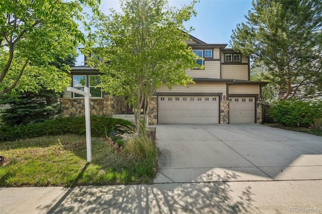 13075 Tamarac St, Thornton, CO 80602 - view of property hidden behind natural elements featuring stone siding, a garage, and driveway