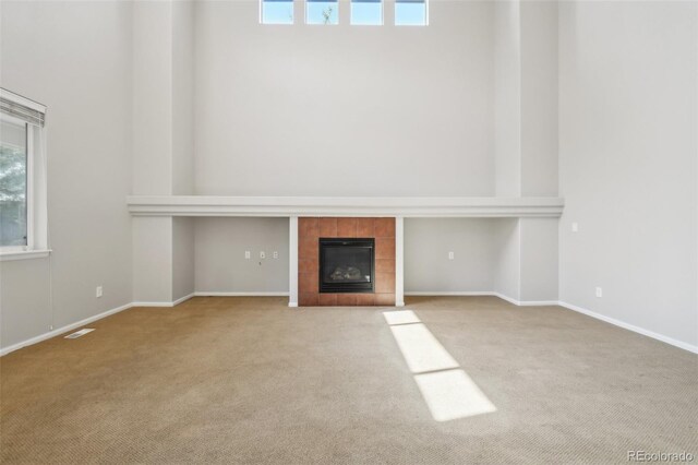 13075 Tamarac St, Thornton, CO 80602 - unfurnished living room with carpet flooring, plenty of natural light, a fireplace, and baseboards
