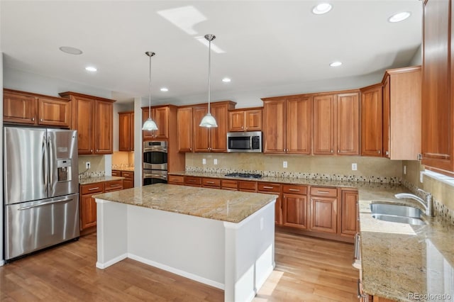 13075 Tamarac St, Thornton, CO 80602 - kitchen with appliances with stainless steel finishes, brown cabinetry, a kitchen island, light stone countertops, and backsplash