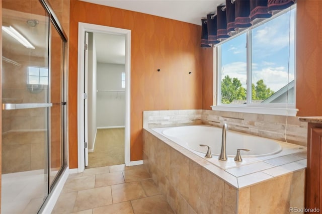 13075 Tamarac St, Thornton, CO 80602 - bathroom featuring a shower stall, a bath, tile patterned floors, baseboards, and a spacious closet