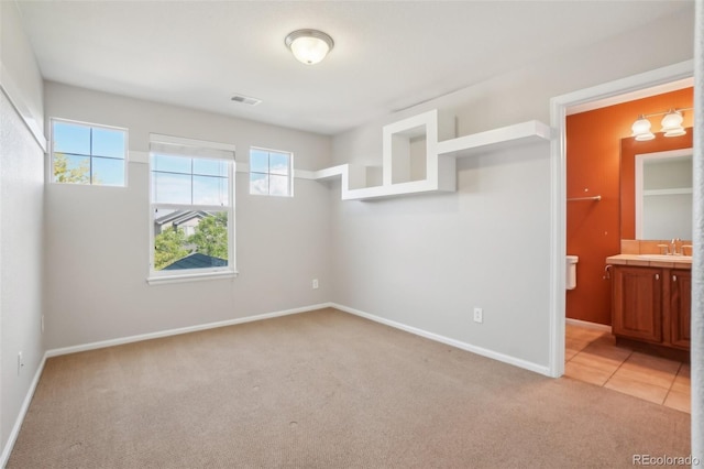 13075 Tamarac St, Thornton, CO 80602 - unfurnished bedroom featuring light colored carpet, baseboards, a sink, and ensuite bath