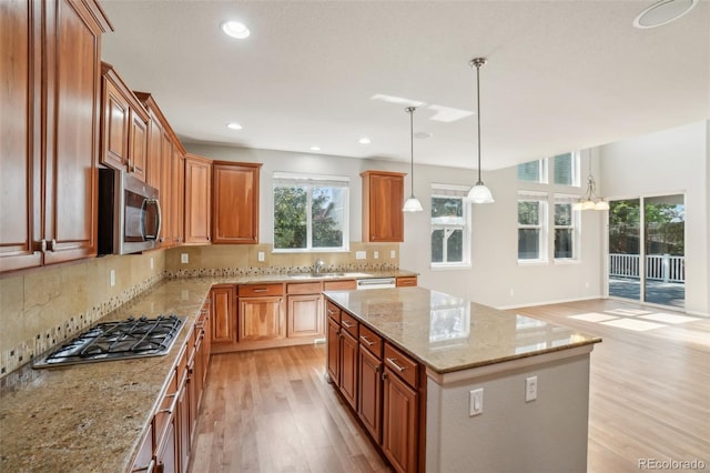13075 Tamarac St, Thornton, CO 80602 - kitchen featuring appliances with stainless steel finishes, light wood finished floors, plenty of natural light, backsplash, and recessed lighting