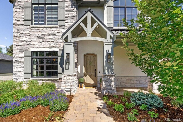 852 Pontiac St, Denver, CO 80220 - doorway to property with stone siding and stucco siding