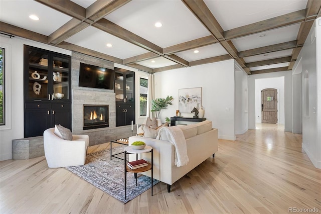 852 Pontiac St, Denver, CO 80220 - living room with coffered ceiling, light wood finished floors, a large fireplace, beamed ceiling, and arched walkways