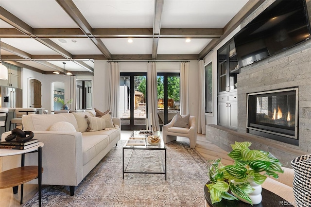 852 Pontiac St, Denver, CO 80220 - living area with coffered ceiling, beamed ceiling, arched walkways, a glass covered fireplace, and wood finished floors