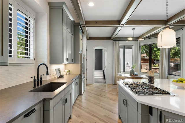 852 Pontiac St, Denver, CO 80220 - kitchen featuring gray cabinets, stainless steel gas cooktop, plenty of natural light, coffered ceiling, and beam ceiling
