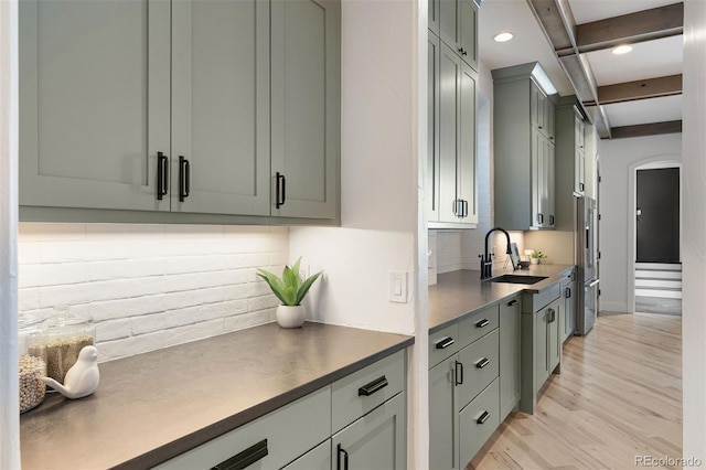 852 Pontiac St, Denver, CO 80220 - kitchen with backsplash, beamed ceiling, light wood-type flooring, arched walkways, and dark countertops