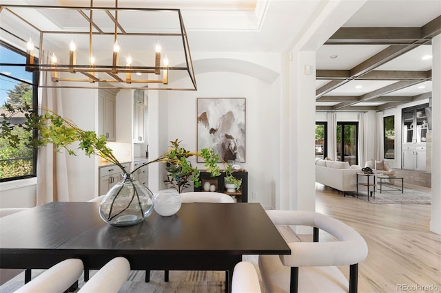 852 Pontiac St, Denver, CO 80220 - dining area with coffered ceiling, a chandelier, healthy amount of natural light, light wood-style floors, and beam ceiling