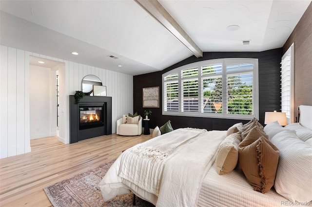 852 Pontiac St, Denver, CO 80220 - bedroom featuring wood finished floors, a glass covered fireplace, an accent wall, and recessed lighting