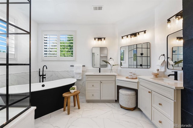 852 Pontiac St, Denver, CO 80220 - full bath with marble finish floors, two vanities, a soaking tub, and tile walls