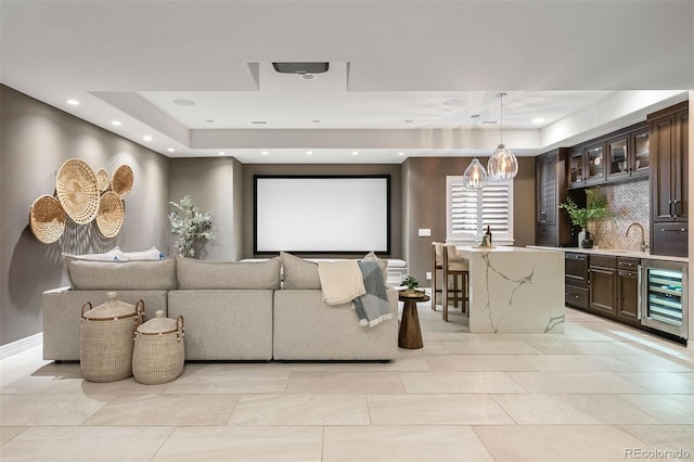 852 Pontiac St, Denver, CO 80220 - home theater featuring beverage cooler, a tray ceiling, recessed lighting, and bar with sink
