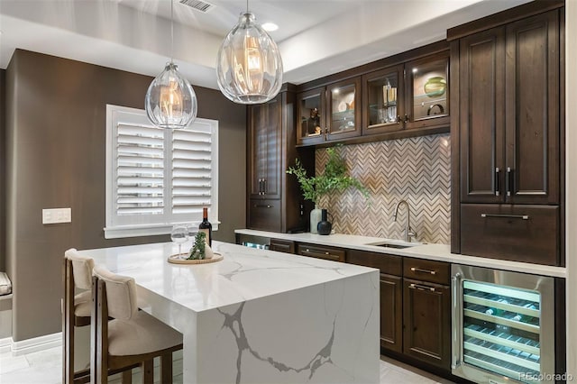 852 Pontiac St, Denver, CO 80220 - bar area with wine cooler, tasteful backsplash, and hanging light fixtures