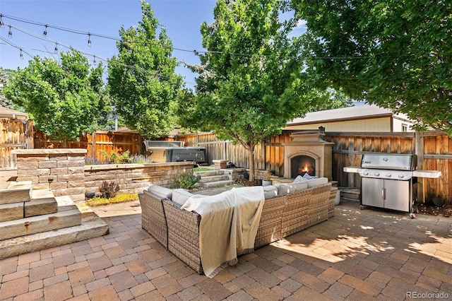 852 Pontiac St, Denver, CO 80220 - fenced backyard featuring an outdoor living space with a fireplace, a patio, and a grill