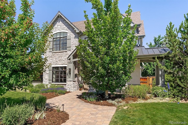 852 Pontiac St, Denver, CO 80220 - view of front of house with stone siding, a standing seam roof, and a metal roof