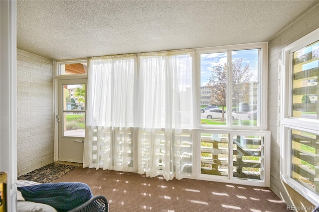 sunroom / solarium featuring a healthy amount of sunlight