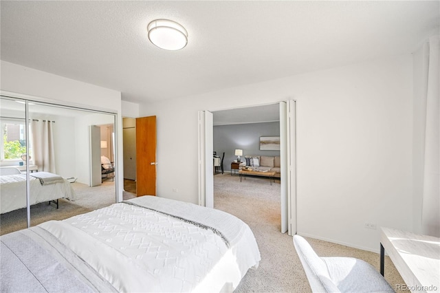 bedroom featuring light carpet and a closet