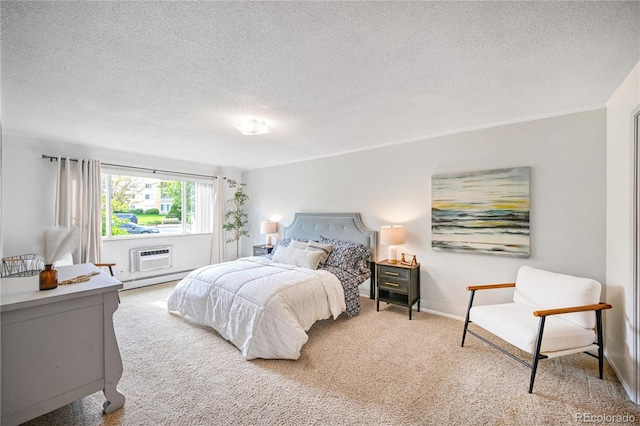 bedroom featuring light carpet, a wall mounted AC, baseboards, and a textured ceiling
