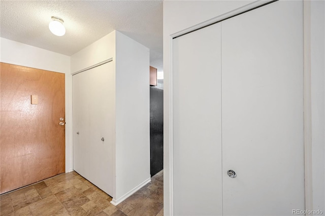 corridor with a textured ceiling