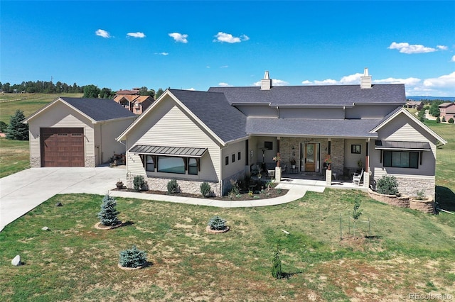 view of front of home with a front lawn, a porch, and a garage