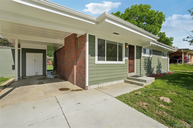 6155 Carr St, Arvada, CO 80004 - entrance to property with a yard, brick siding, and driveway