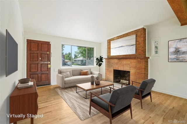 6155 Carr St, Arvada, CO 80004 - living room featuring light wood finished floors, a fireplace, and baseboards
