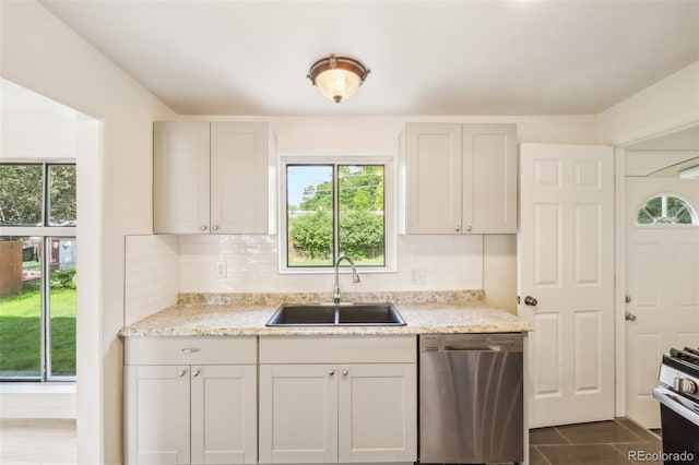 6155 Carr St, Arvada, CO 80004 - kitchen featuring stainless steel appliances, a sink, plenty of natural light, and decorative backsplash