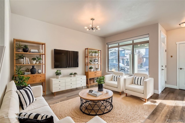 living room featuring hardwood / wood-style flooring and a notable chandelier