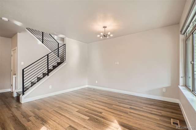 interior space featuring wood-type flooring and an inviting chandelier