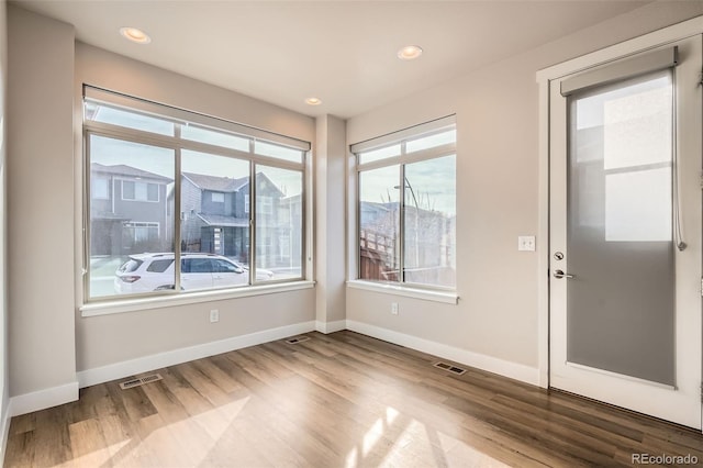 spare room featuring hardwood / wood-style floors