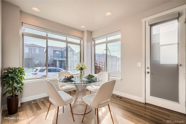 dining space with light hardwood / wood-style flooring