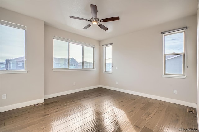 empty room featuring hardwood / wood-style flooring and ceiling fan