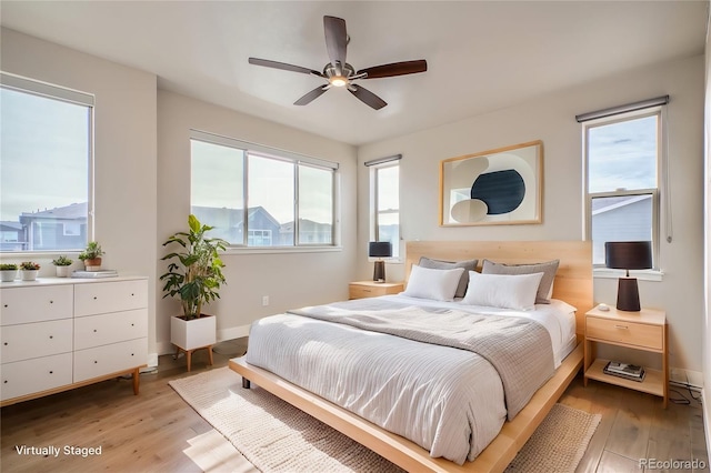 bedroom with ceiling fan and light hardwood / wood-style floors