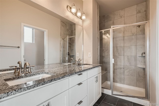 bathroom with tile patterned flooring, vanity, and a shower with shower door