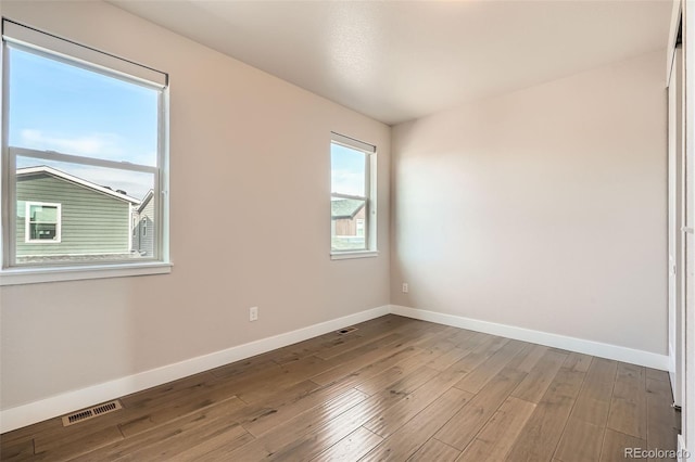 spare room with hardwood / wood-style floors