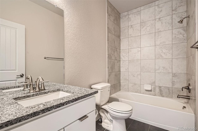 full bathroom with tiled shower / bath, vanity, tile patterned floors, and toilet