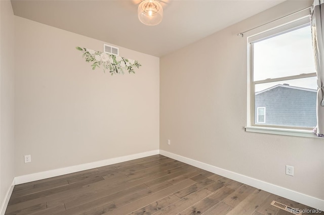 spare room with dark wood-type flooring