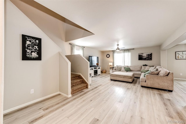 living room featuring ceiling fan and light wood-type flooring