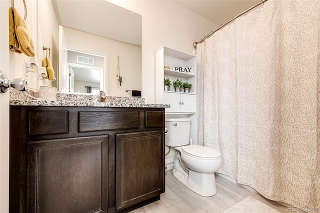 bathroom featuring hardwood / wood-style floors, vanity, and toilet