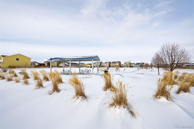 snowy yard featuring a pergola