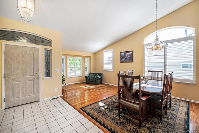 1010 Home Farm Cir, Denver, CO 80234 - dining space with lofted ceiling, a chandelier, and light tile patterned floors