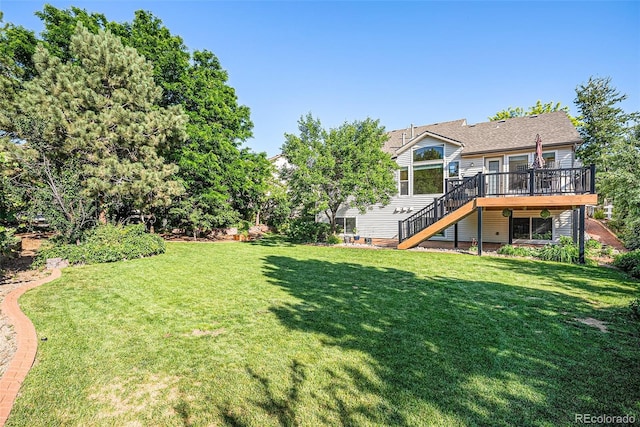 1010 Home Farm Cir, Denver, CO 80234 - view of grassy yard featuring stairway and a wooden deck
