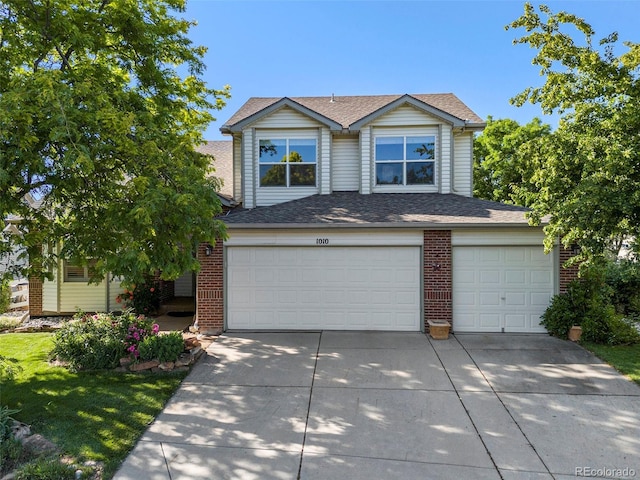 1010 Home Farm Cir, Denver, CO 80234 - view of front of property with concrete driveway, brick siding, a garage, and a shingled roof