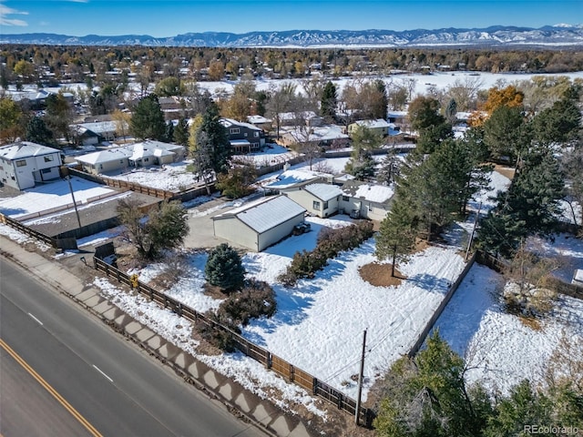 snowy aerial view featuring a mountain view