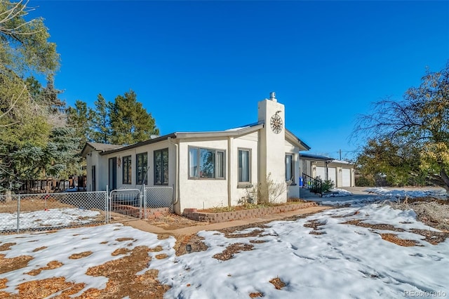 view of snow covered exterior with a garage