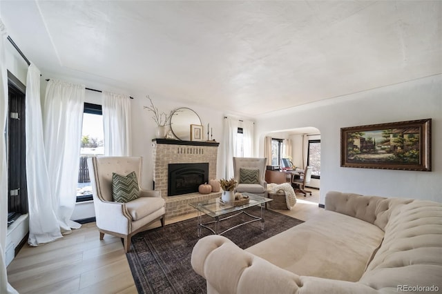 living room featuring a fireplace and light hardwood / wood-style flooring