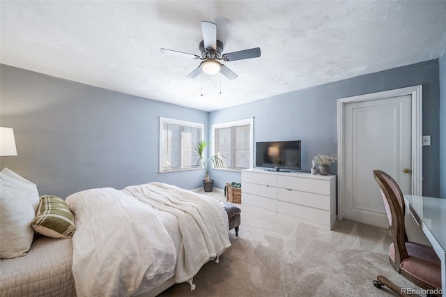 bedroom featuring ceiling fan and light colored carpet