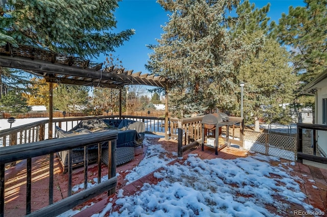 snow covered deck with a grill